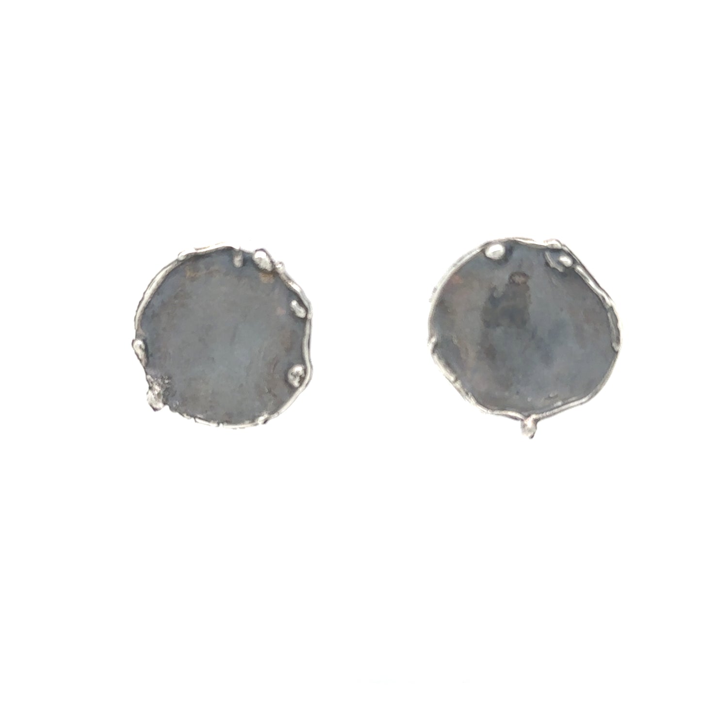 Capture the mesmerizing dance of water and sand with our Shoreline Ripple Earrings. These exquisite round pieces feature intricately detailed edges that mirror the gentle ebb and flow of waves caressing Whidbey Island's pristine beaches.