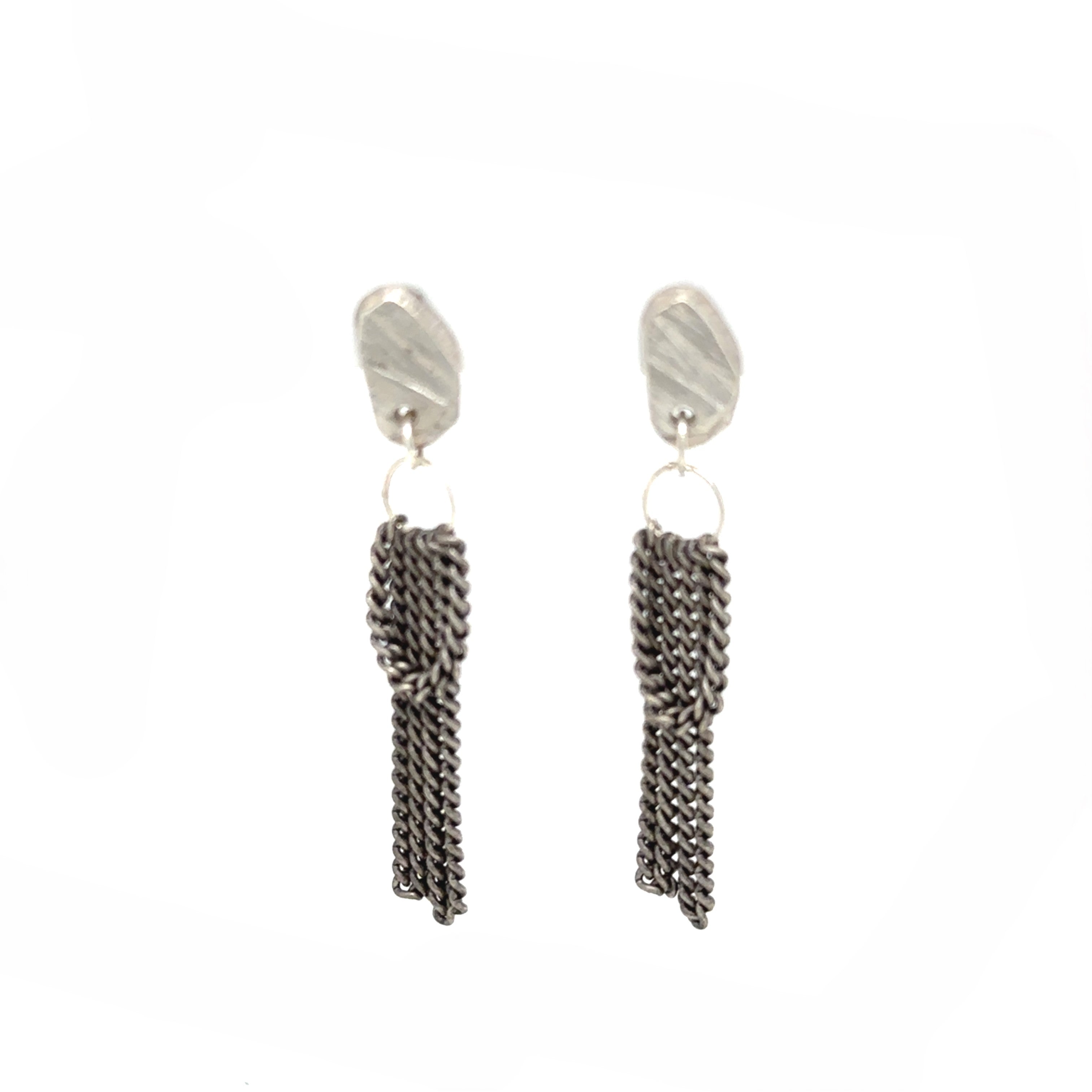 Experience the gentle allure of Whidbey Island's hidden waterfalls with our Cascade Studs. They capture the essence of water's delicate journey from stone to sea, embodying the island's secret, shimmering cascades.

Each stud features a small, intricately textured piece that evokes the rugged beauty of Whidbey's rocky outcrops. The surface mirrors the weathered stones shaped by centuries of flowing water and catches the light much like sunlight playing on rippled water, adding a subtle sparkle.