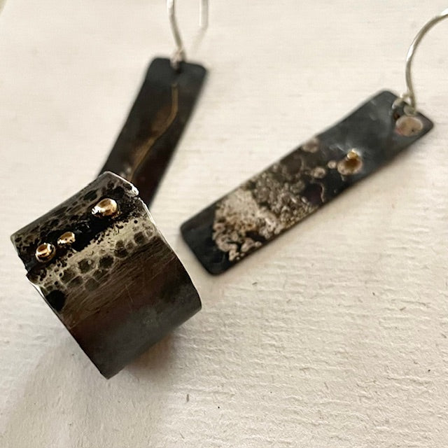 Embrace the weathered beauty of Whidbey Island's shores with our Driftwood Earrings. They capture the essence of sun-bleached wood transformed by its journey through salt and sea, reimagined in precious metals.