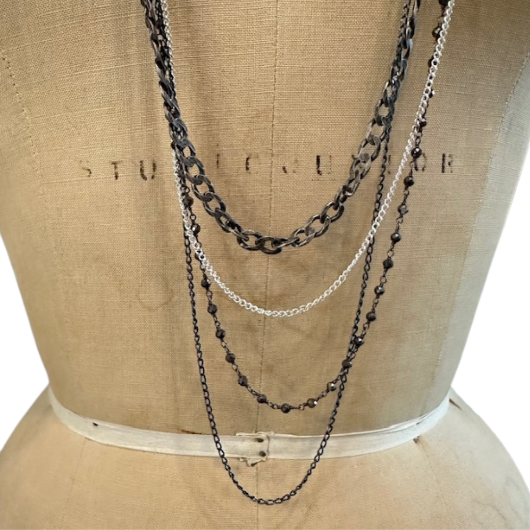 Immerse yourself in the depths of Whidbey Island's waters with our Ocean's Tapestry Necklace. This stunning 36-inch layered piece is a wearable ode to the complex ecosystem beneath the waves. 
The necklace is a harmonious blend of various elements, each carefully chosen to represent different aspects of the ocean's beauty. The various chains represent the flow of the water &  the pyrite stones represent the sun’s reflection upon the water.