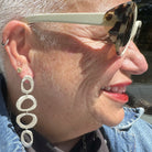 Mystic Statement Earrings in Silver and Evil Eye Stud Earrings in 18kt Gold on person