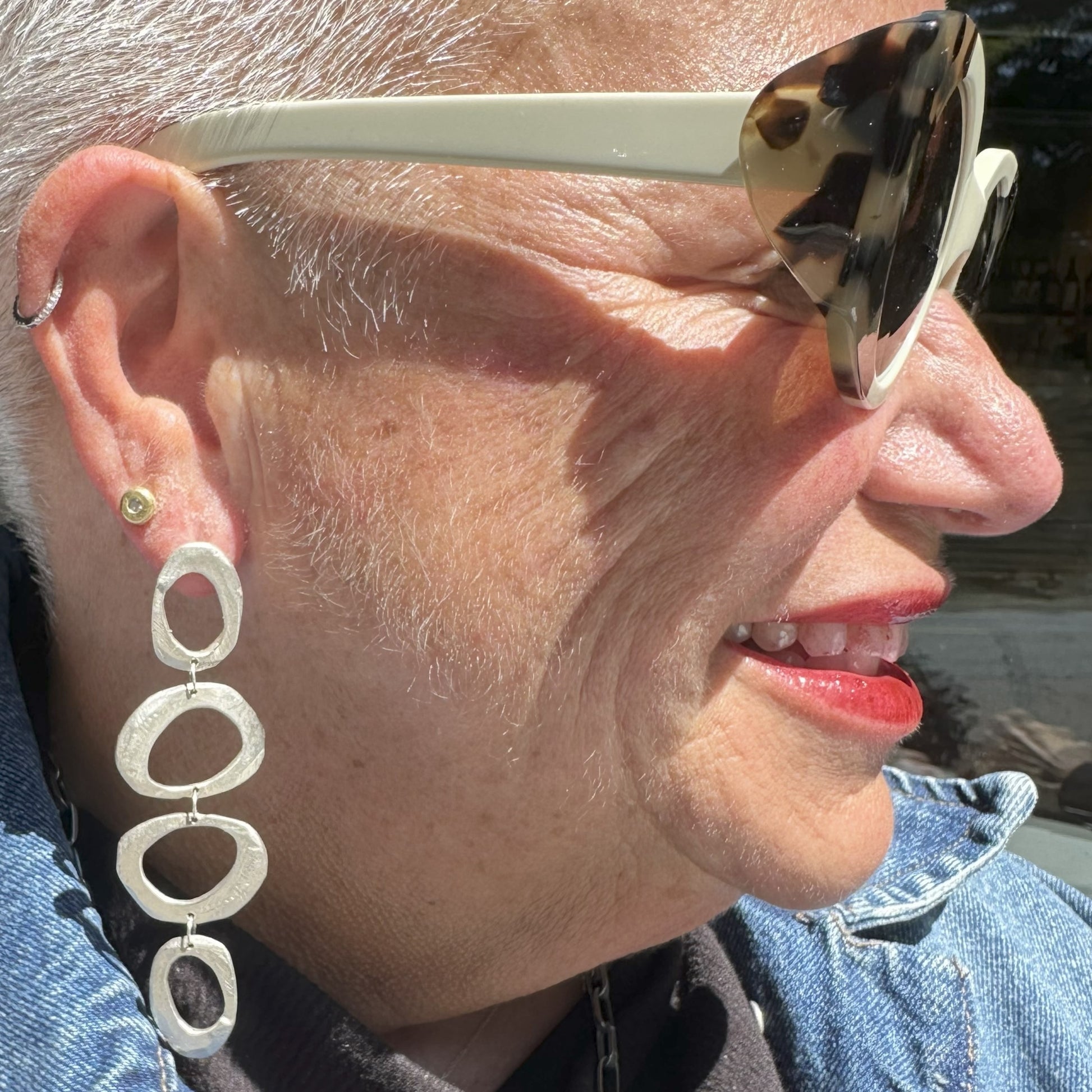 Mystic Statement Earrings in Silver and Evil Eye Stud Earrings in 18kt Gold on person