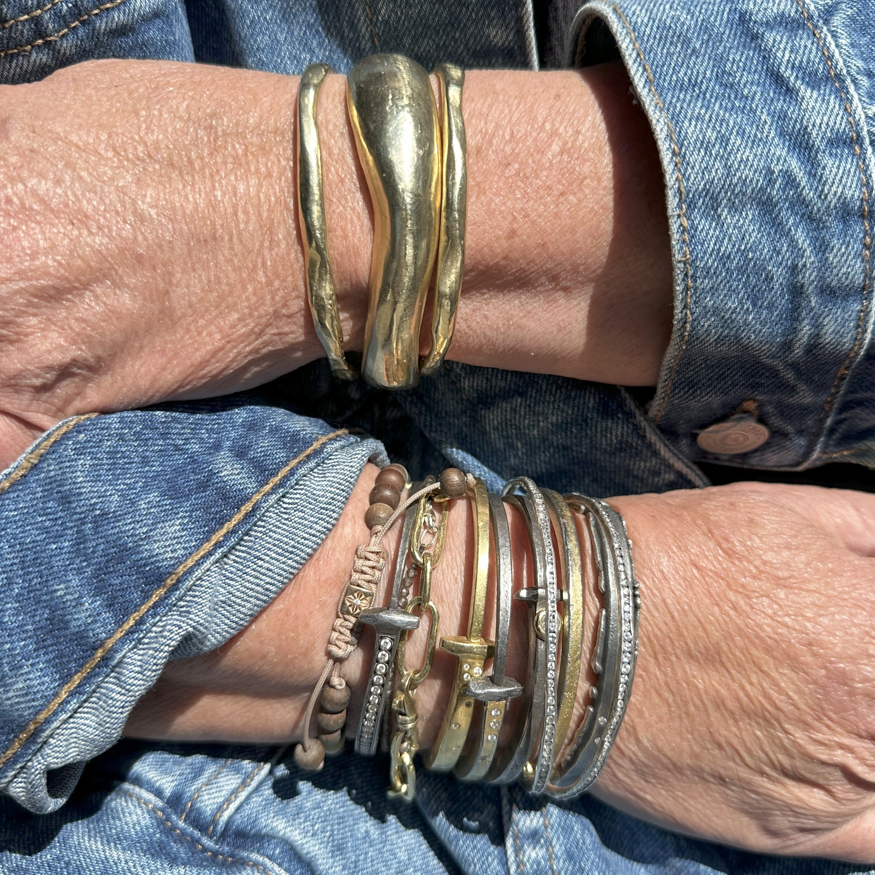 Customer stack of own bracelets with the Tidal Force Cuff on right arm. Left arm features 2 Divine Thin Cuffs and 1 Divine Wide Cuff. 