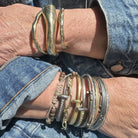 Customer stack of own bracelets with the Tidal Force Cuff on right arm. Left arm features 2 Divine Thin Cuffs and 1 Divine Wide Cuff. 