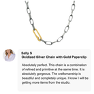 Oxidized silver chain with gold paperclip on a white background, featuring a customer review.