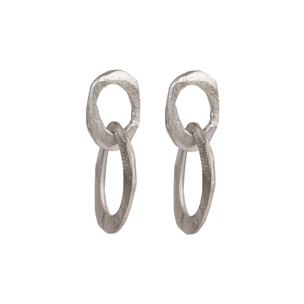 The Skipping Stones Double Oval Earrings feature two interconnected oval shapes, crafted with precision to create a fluid, harmonious design. Each pair shimmers in either Sterling Silver or Bronze with an otherworldly charm that catches both light and attention. The double oval structure allows for graceful movement, adding a dynamic element to your look. 