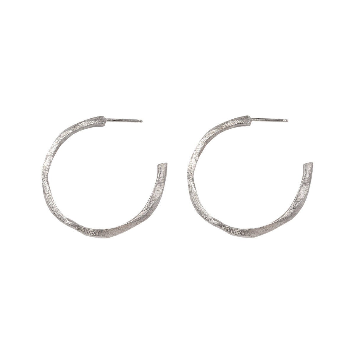 Our Small Hoop Earrings feature the same richly textured surface as their larger counterparts, evoking the weathered elegance of historic monoliths in a more subtle form. The Small Hoops are designed for versatility, perfect for everyday wear or as part of a curated ear stack.