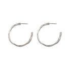 Our Small Hoop Earrings feature the same richly textured surface as their larger counterparts, evoking the weathered elegance of historic monoliths in a more subtle form. The Small Hoops are designed for versatility, perfect for everyday wear or as part of a curated ear stack.